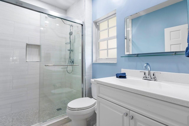 bathroom with walk in shower, vanity, and toilet