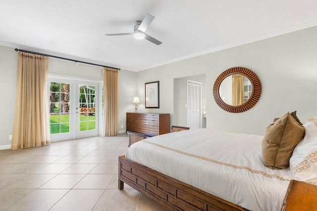 tiled bedroom with ceiling fan, french doors, a textured ceiling, and ornamental molding