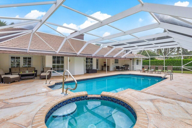 view of pool featuring outdoor lounge area, a patio, an in ground hot tub, and a lanai