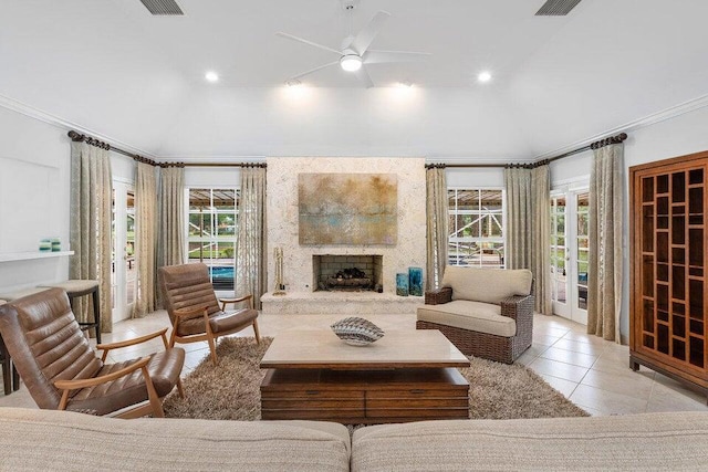 living room with plenty of natural light, a fireplace, and crown molding