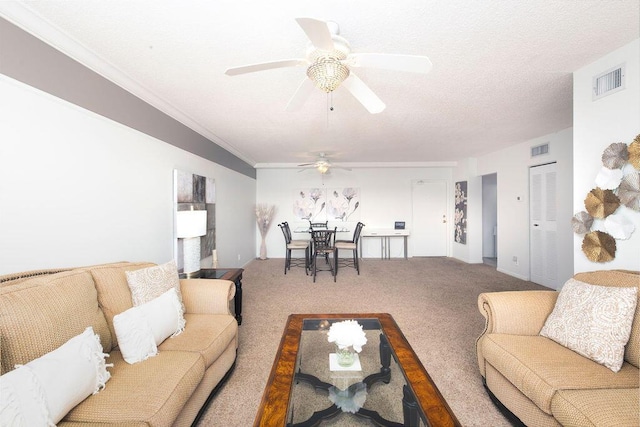 living room with carpet flooring, ceiling fan, ornamental molding, and a textured ceiling