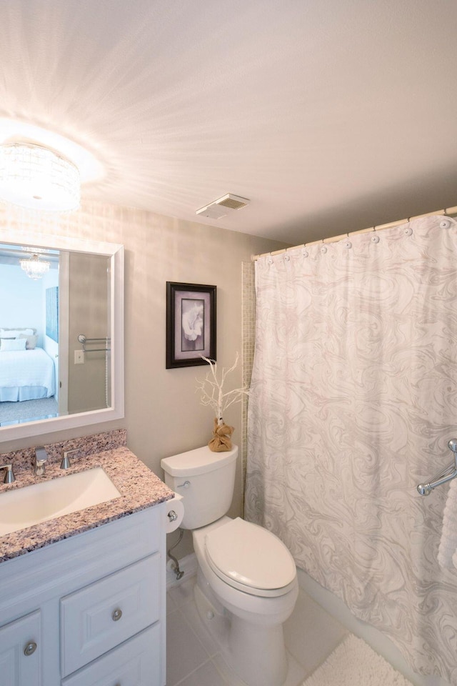 bathroom featuring tile patterned floors, vanity, and toilet