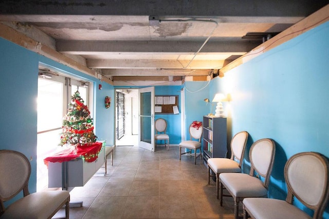 interior space featuring tile patterned flooring and beam ceiling