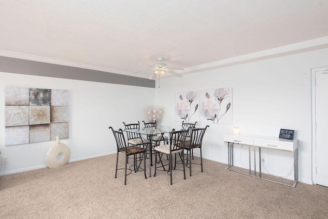 dining room with a textured ceiling, ceiling fan, ornamental molding, and light carpet