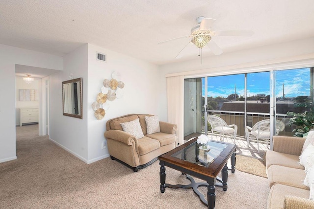 carpeted living room with ceiling fan