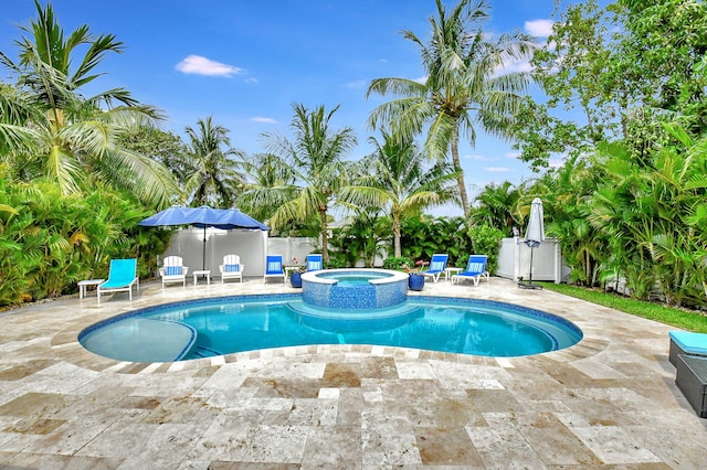 view of swimming pool with an in ground hot tub and a patio area