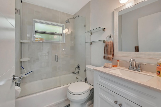 full bathroom featuring enclosed tub / shower combo, vanity, and toilet