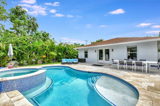 view of swimming pool featuring outdoor lounge area, an in ground hot tub, a patio, and french doors