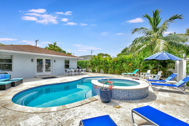 view of swimming pool with an in ground hot tub, a patio area, and french doors