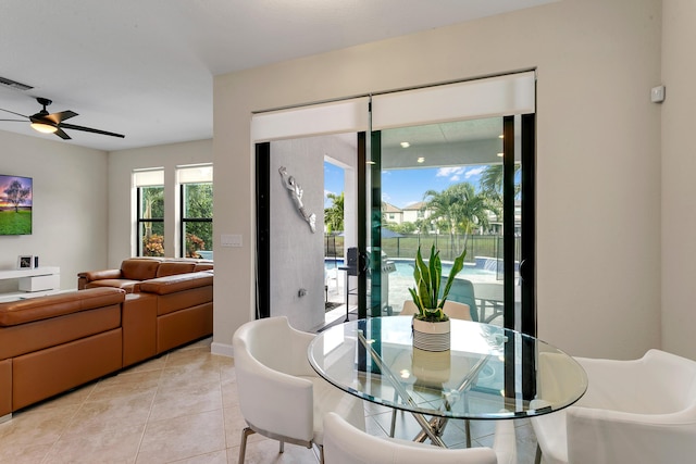 tiled dining space featuring ceiling fan