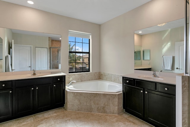 bathroom featuring tile patterned floors, vanity, and plus walk in shower