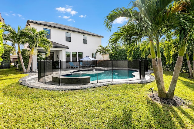 view of swimming pool featuring a yard and a patio