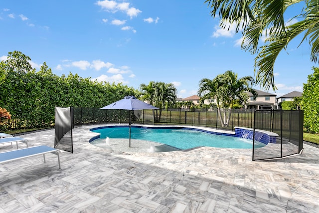 view of swimming pool with pool water feature and a patio