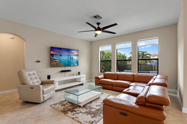 tiled living room featuring ceiling fan