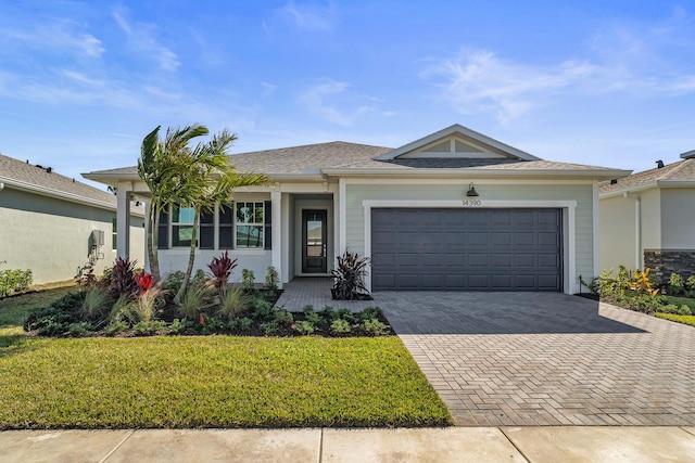 single story home with a front yard and a garage