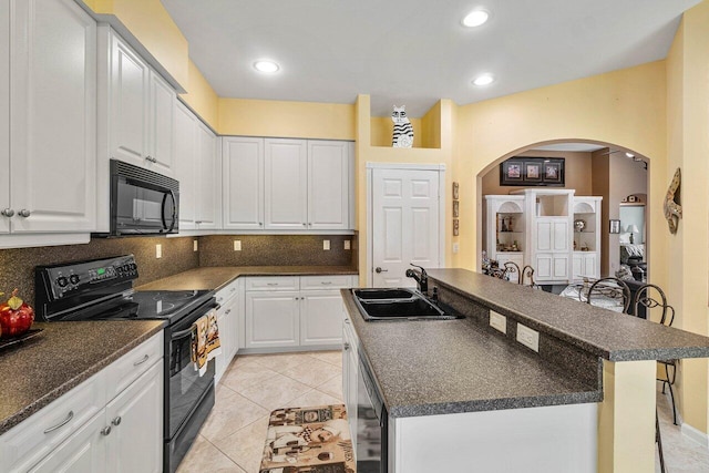 kitchen with white cabinetry, a center island, black appliances, and sink