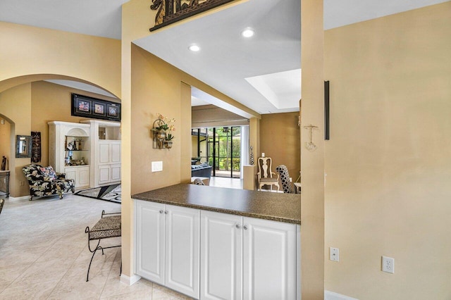 kitchen featuring white cabinets and light tile patterned flooring