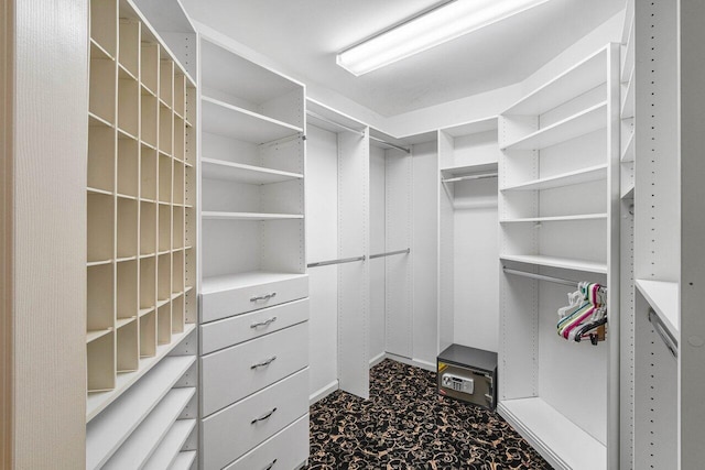 walk in closet with carpet flooring