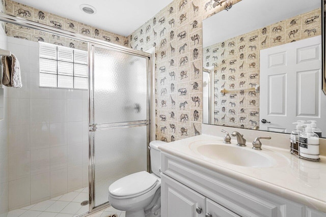 bathroom featuring vanity, toilet, and a shower with door