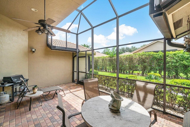 view of patio featuring a lanai and ceiling fan