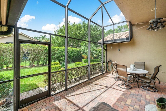 sunroom featuring a wealth of natural light and ceiling fan