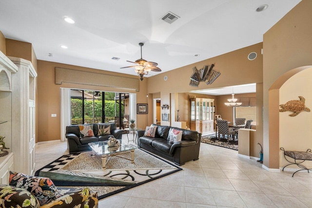 living room featuring light tile patterned flooring and ceiling fan with notable chandelier