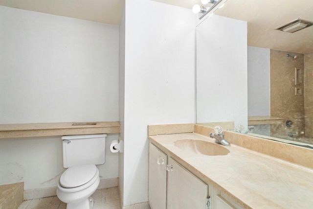 bathroom with vanity, tile patterned floors, and toilet