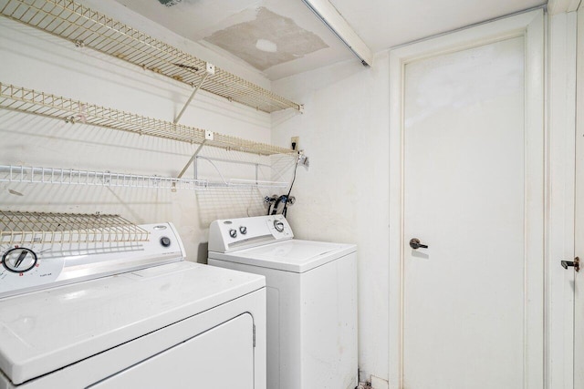 clothes washing area featuring separate washer and dryer