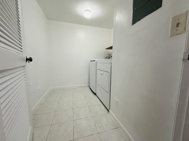 laundry area with light tile patterned floors and washer and dryer