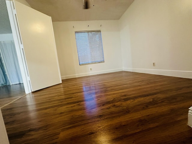 unfurnished room with dark hardwood / wood-style flooring