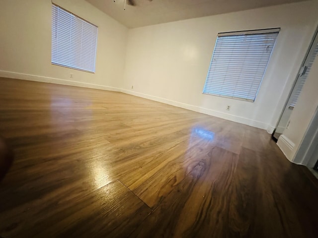 unfurnished room with ceiling fan and wood-type flooring