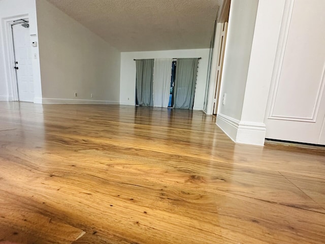 spare room with hardwood / wood-style flooring and a textured ceiling