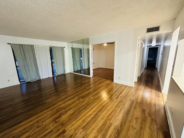 spare room with wood-type flooring and a textured ceiling