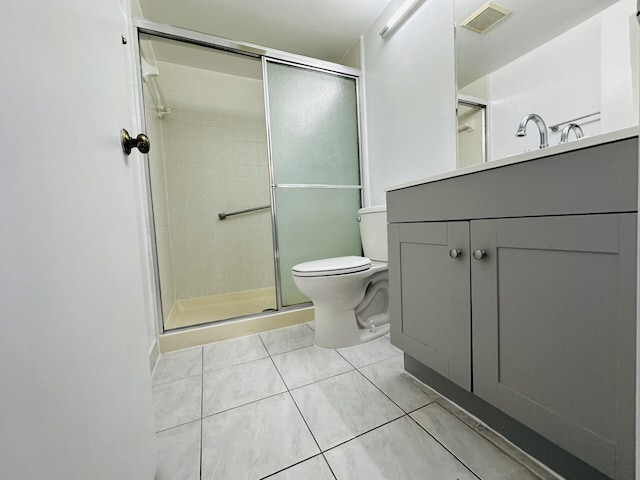 bathroom with vanity, toilet, an enclosed shower, and tile patterned flooring