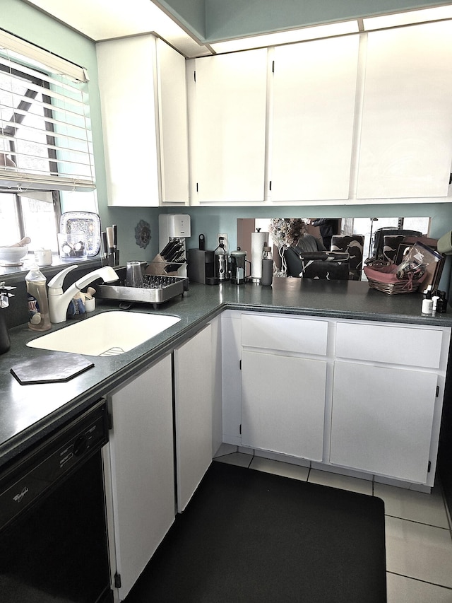 kitchen with dishwasher, white cabinetry, and sink