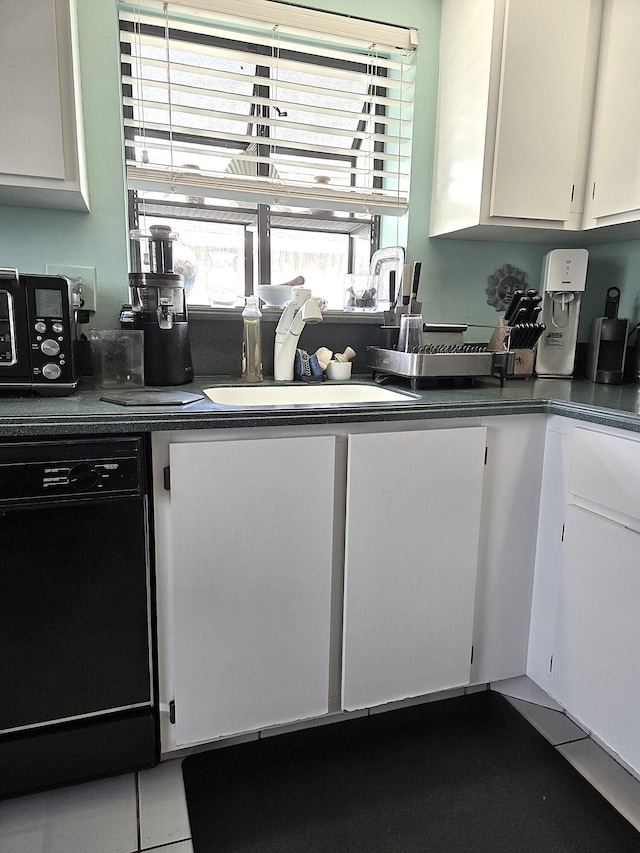 kitchen with white cabinetry, sink, dishwasher, and tile patterned flooring