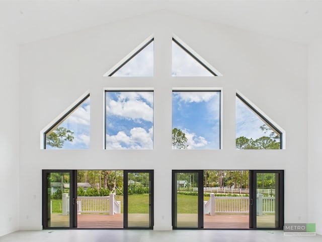 13613 157th Ct N, Jupiter, FL 33478 - unfurnished living room featuring a towering ceiling
