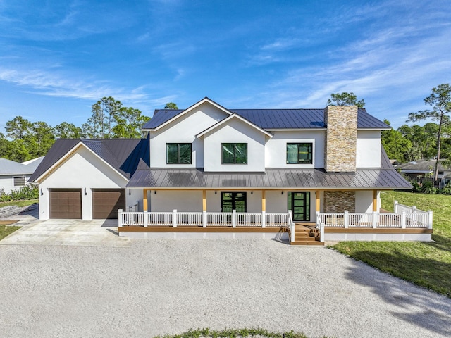 13613 157th Ct N, Jupiter, FL 33478 - modern farmhouse style home with a porch, stucco siding, driveway, a standing seam roof, and a chimney