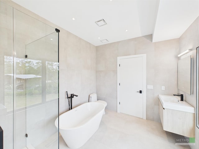 13613 157th Ct N, Jupiter, FL 33478 - full bathroom featuring tile walls, a shower stall, a freestanding tub, and vanity