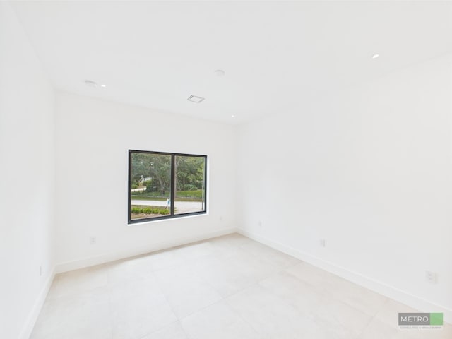 13613 157th Ct N, Jupiter, FL 33478 - unfurnished room with light tile patterned floors and baseboards