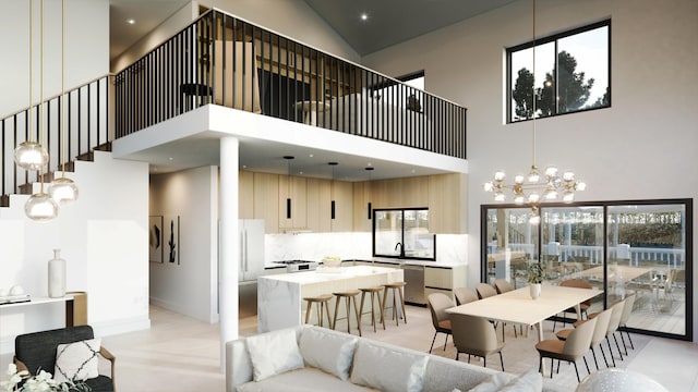 tiled dining area with an inviting chandelier, a towering ceiling, sink, and a wealth of natural light