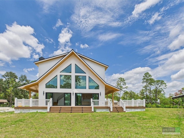 13613 157th Ct N, Jupiter, FL 33478 - rear view of property featuring a yard, stucco siding, and a wooden deck