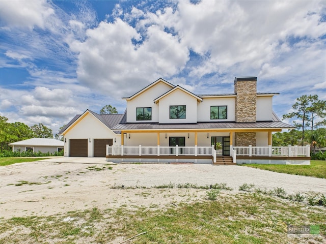 13613 157th Ct N, Jupiter, FL 33478 - modern inspired farmhouse featuring concrete driveway, a standing seam roof, covered porch, a garage, and metal roof