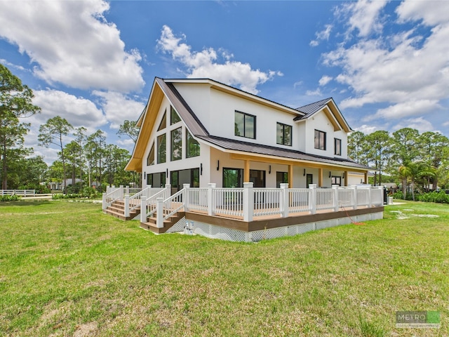 13613 157th Ct N, Jupiter, FL 33478 - rear view of house with covered porch, a yard, and stucco siding