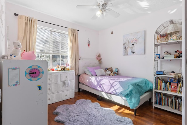 bedroom with dark hardwood / wood-style floors and ceiling fan