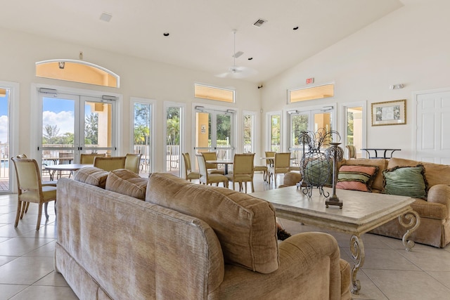 living room with french doors, high vaulted ceiling, ceiling fan, and light tile patterned flooring