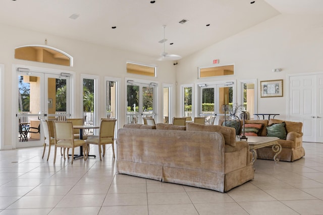 living room with french doors, high vaulted ceiling, and light tile patterned floors