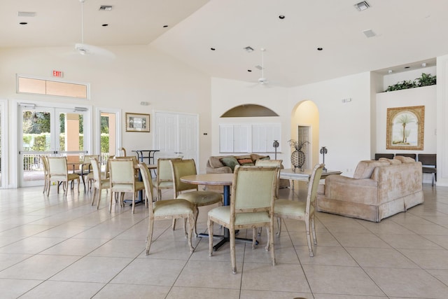 tiled dining room featuring french doors, ceiling fan, and high vaulted ceiling