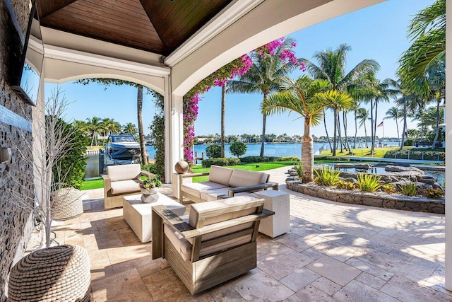 view of patio with outdoor lounge area and a water view