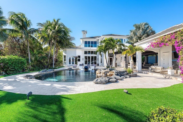 view of pool featuring a patio area and a yard